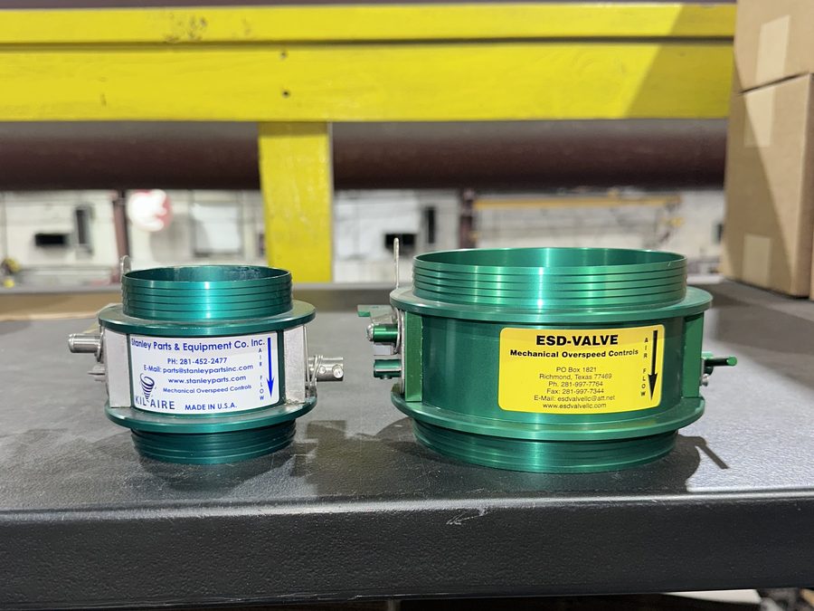 Anodised aluminium KilAire shutdown valves, 3 inch and 5 inch, side by side on a shop bench